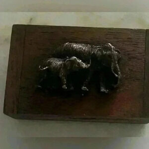 Right facing trunk up elephant teak wood trinket box 3.3 x 2 inches.